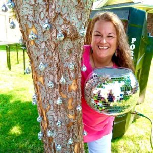 Michele in park in daytime with disco ball in her hands